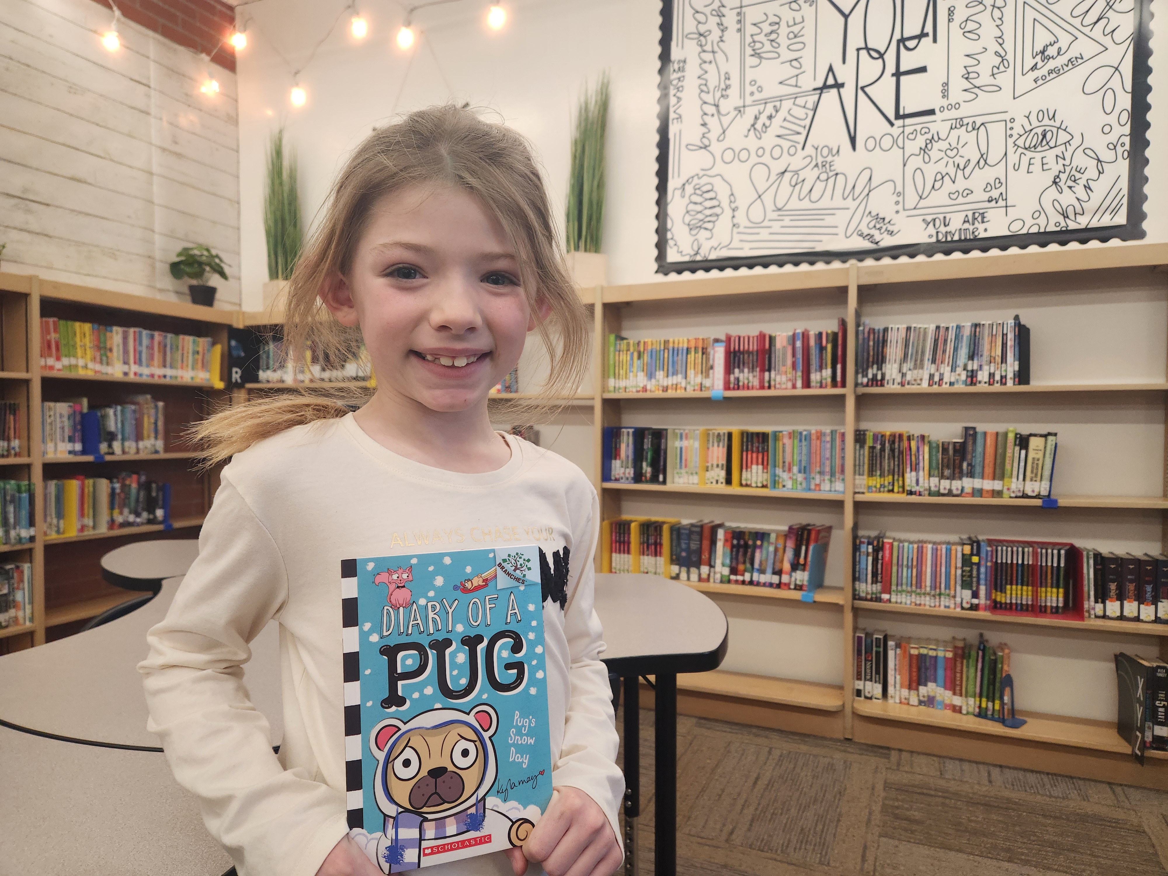 Sunnyside 2nd grader with her Read 2 Me book